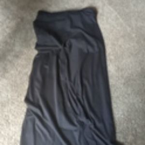 A long black skirt with slits and black pants lace